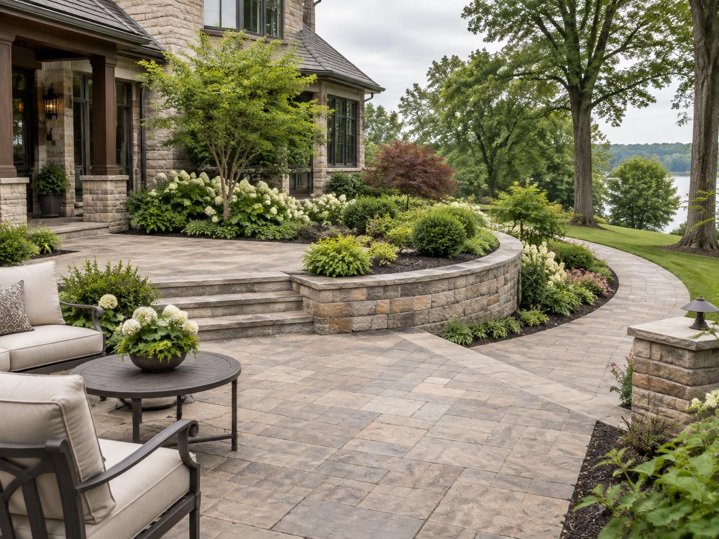 Finished stone patio, retaining wall, walkway, and landscaped garden beds